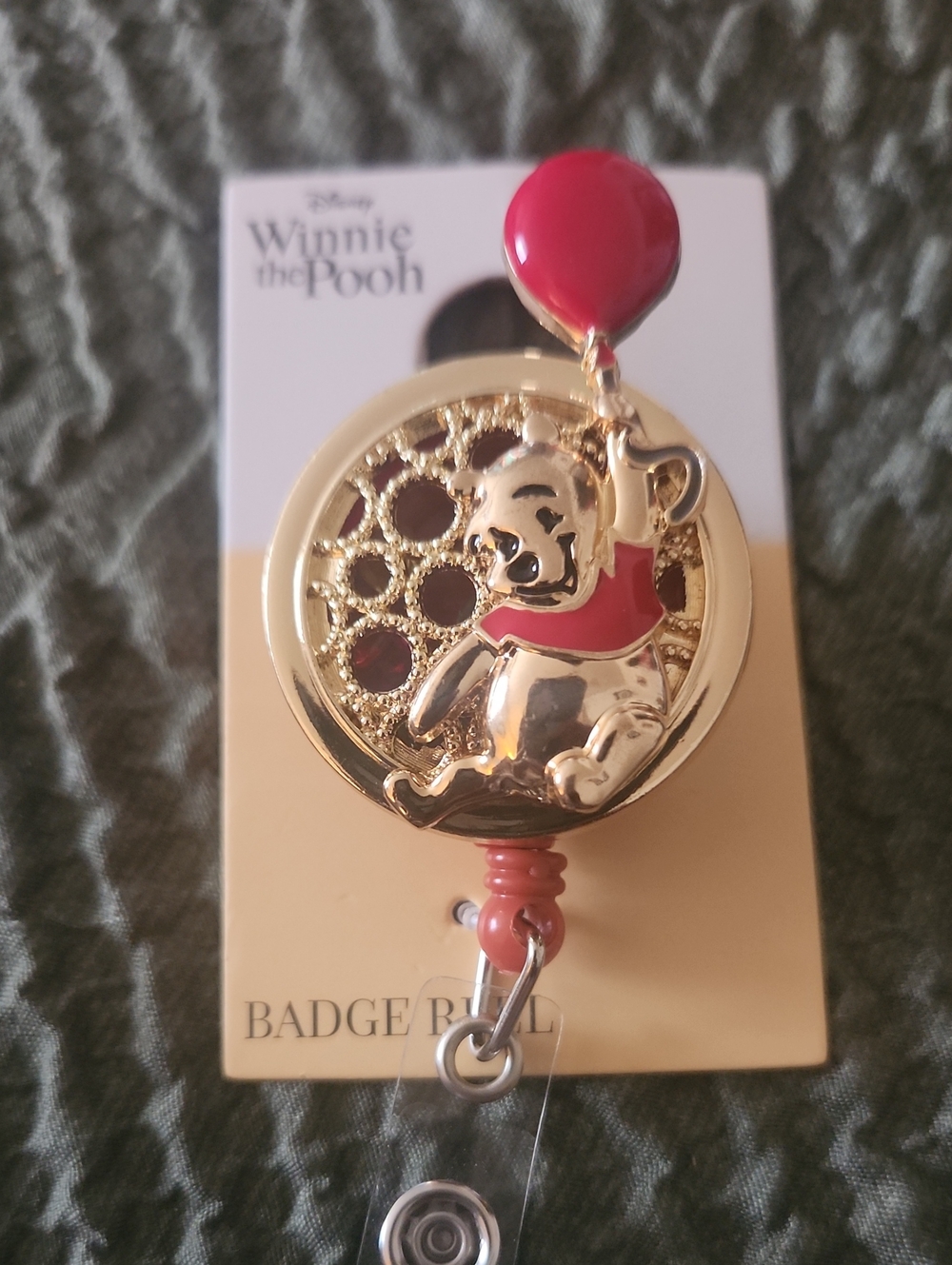 Disney Gold-Tone Winnie the Pooh Badge Reel with Red Balloon Accents
